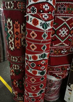 red and white rugs are on display in a store