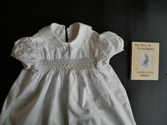 An authentic vintage dress C.1950s in great condition. I'm not sure what the fabric content is as there are no labels but it washed well. Has a pretty Peter Pan collar, three button fastening at the back, gathering puff short sleeves and a panel of pretty smocking in pastel colours. The dress measures 24" long and 24" across the chest.  Very sweet and in good condition.Postage rates between UK and USA have risen dramatically since 01.07.20. If you are buying from USA, please contact me as I may Vintage Girls Dresses, Pastel Colours, Vintage Girls, Pan Collar, Dress C, Peter Pan Collar, Vintage Dress, Great Books, True Vintage