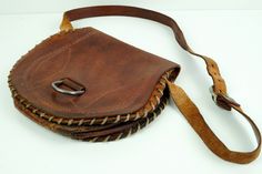 Vintage Embossed Genuine Leather Bag, Shoulder Bag, Handmade Handbag, Nordic bag, Saddle Bag, Brown Leather Handbag. Very rare Boho bag. Cognac color bag This lovely bag is made from thick leather. Mid tan leather and Embossed patterns on front and at the back Has medium length shoulder strap, the inside is not lined and has two large compartment . Closes with with Poppers Great collectible bag. Very rare find. Good vintage condition for its age with normal marks, wear and rubbing nothing major Vintage Brown Bag For Everyday Use, Brown Saddle Shoulder Bag With Removable Pouch, Handmade Vintage Brown Travel Bag, Vintage Brown Handmade Travel Bag, Vintage Brown Bag With Adjustable Strap, Vintage Handmade Bag For Everyday Use, Vintage Handmade Bags For Everyday, Vintage Brown Satchel Bag, Vintage Handmade Everyday Bag