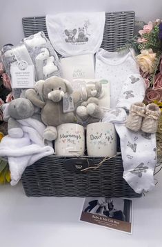 a basket filled with baby items and flowers