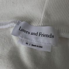 a label on a white shirt that says lovers and friends