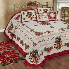 a christmas themed bed spread with bells and poinsettis on it, next to a fireplace