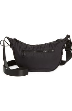 a black fanny bag sitting on top of a white floor next to a purse strap