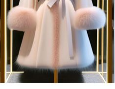 a white coat with pink fur collar and cuffs