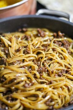 some noodles are being cooked in a skillet