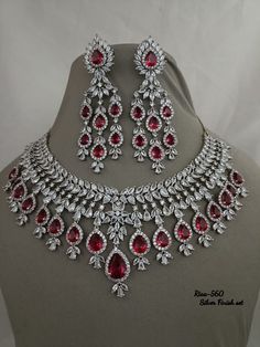 Handmade item Dispatches from a small business in India Materials: cubic zirconia Jewellery type: Earrings, Necklace Description Ruby Cubic Zirconium Necklace/Indian Necklace/ Indian Jewelry/ American Diamond Necklace/ Wedding Necklace/ Diamond Necklace/ Red This gorgeous Diamond bridal set is made keeping in mind the Elegance of an Indian bride. Keeping the look heavy but with simple earrings & matching mathapatti and A Nath . The Sabyasachi Inspired Bridal Set is Sure to Make you Big Day . Details : Made of premium quality Diamond Polki on all pieces. Green/White/Maroon cubic zirconia and Pearls motis. Customized orders takes 3 to 4 weeks, depending on piece requirements. Ayesha Creation Jewelry pieces can be customized in accordance with your requirement. Indian Ruby Jewellery, Big Jewelry Necklace, Polki Jewellery Sabyasachi, Small Diamond Necklace, Heavy Jewellery, Elegant Wedding Jewelry, Ruby Jewelry Necklaces, Diamond Necklace Wedding, Stone Jewelry Necklace