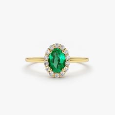 Emerald Ring / 14k Classic Oval Cut Emerald Ring with Surrounding Diamonds / Natural Emerald Ring in 14k Solid Gold / Mothers Day Gift Item Features * Made to Order. * Gold KT: 14K * Custom Gold Color: Rose Gold, Yellow Gold, White Gold * Number of Emeralds and Size : 1 Oval Emerald 6x4MM in Size * Number of Diamonds:  14 Round diamonds 1.30MM in Size * Total Emerald CTW: 0.40ctw * Total Diamond CTW: 0.15ctw * Diamond Color Clarity: G Color SI Clarity * Setting Type: Prong * Band Width: 1.25mm * Ready to Ship in 7-10 Business Days ▶ See more of our Emerald Jewelry - https://etsy.me/3QCyZBQ ▶ See our storefront here - http://etsy.me/2lUcVnH  ▶ All store sections here * Diamond Rings - http://etsy.me/2lwKUl8 * Diamond Earrings - http://etsy.me/2lyqVBP * Diamond Necklace - http://etsy.me/2mqa Formal Oval Cluster Ring With Halo Design, Oval Halo Ring For Formal Occasions, Green Oval Cluster Ring Fine Jewelry, Oval Diamond Ring With Center Stone, Heirloom Oval Emerald Ring As May Birthstone, Formal Oval Diamond Ring With Halo Design, Heirloom Oval Green Diamond Ring, Heirloom Green Oval Diamond Ring, Emerald Oval Cabochon Ring In Fine Jewelry Style