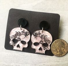 Inspired by the goddess Persephone, these earrings are the perfect mix of dark and gothic, while still exuding touches of spring and growth. Available on sterling silver or hypoallergenic stainless steel studs. Black Skull Earrings For Gift, Black Skull Print Earrings As Gift, Edgy Skull-shaped Earrings For Gift, Edgy Skull Shaped Earrings For Gift, Black Gothic Earrings With Skull Print, Punk Skull Print Earrings Gift, Punk Skull Print Earrings For Gift, Punk Style Skull Print Earrings As Gift, Gothic Skull Print Earrings For Gift