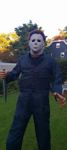 a man in a halloween costume holding a knife