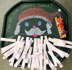 santa's beard on a blackboard with white tape and gummy sticks attached to it