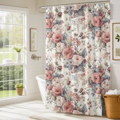 a floral shower curtain with pink flowers on it in a bathroom next to a tub