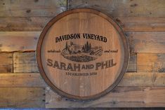 a wooden barrel sitting on the side of a wall next to a sign that says davidson vineyard