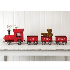 a red toy train with a teddy bear on it