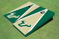 a green and white cornhole game set on grass