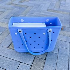 a blue tote bag sitting on the ground