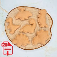 the cookie cutters are shaped to look like animals on a wooden plate with an arrow pointing at them