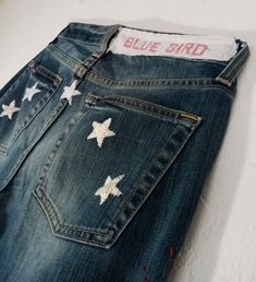 a pair of jeans with white stars on them