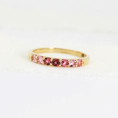 Ombre Ring Band in 14k Solid Gold, Half Eternity Gradient Pink Tourmaline Ring, Colorful Gemstone Ring, Anniversary Gift, October Birthstone . DETAILS ABOUT THE RING, MATERIALS AND STONE Ring Band: 14K YELLOW GOLD Ring Band size: 2.54mm wide band Gemstones: 2mm natural pink gradient tourmalines. Pave setting. 2mm tall from finger. Total 7 pink tourmalines. Matching hoop earrings are available from this link; https://www.etsy.com/listing/1164157904/pink-tourmaline-hoop-earrings-14k-gold? SIZE : P 14k Gold Multi-stone Stackable Rings, Classic Pink Half Eternity Jewelry, Pink Gemstone Stackable Promise Rings, Pink Multi-stone Rings For Anniversary, Pink Stackable Half Eternity Rings As Gift, Fine Jewelry 14k Gold Half Eternity Birthstone Ring, 14k Gold Multi-stone Eternity Band, 14k Gold Half Eternity Birthstone Ring, Pink Sapphire Half Eternity Jewelry For Anniversary