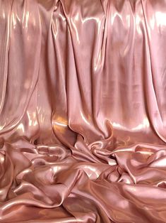 an image of shiny pink material that looks like fabric