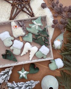 christmas decorations are displayed in a box on the floor