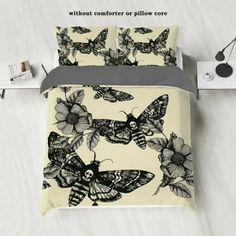 an image of a bed with butterflies and flowers on it in black and white colors