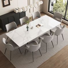 a dining room table with white chairs around it