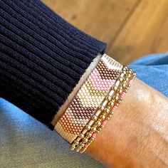 a person wearing two different bracelets on their arm