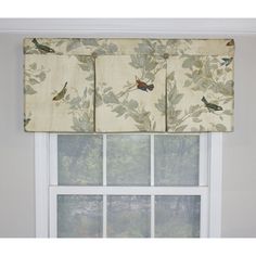 the window valance has birds on it and is decorated with green leafy leaves