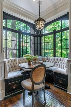 an elegant dining room with wood floors and large windows