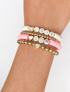 the bracelets are decorated with gold, white and pink beads that spell out love