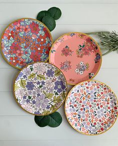 four colorful plates with floral designs on them