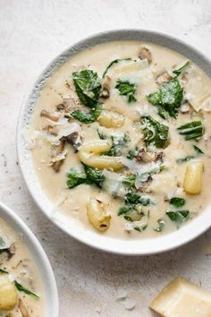 two bowls of soup with cheese and spinach