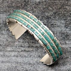 Zuni bracelet featuring 3 rows turquoise inlay handcrafted by outstanding Zuni artist Sheldon Lalio. Bracelet is almost 5/8" wide, 5 " inside tip to tip and has a 1 1/8" opening which should fit a wrist circumference of up to 6 ". This bracelet weighs right at 29.5 grams. Artisan Turquoise Bracelets With Inlay, Adjustable Turquoise Bracelet With Inlay, Elegant Turquoise Inlay Bracelet, Vintage Turquoise Bracelets With Inlay, Southwestern Sterling Silver Bracelet With Turquoise Inlay, Turquoise Bracelet, The Row, Turquoise, Thing 1