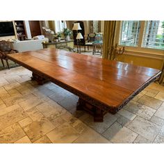 a large wooden table sitting in the middle of a living room