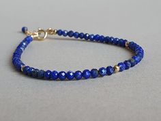 Such a delicious bracelet with vibrant blue genuine lapis lazuli gemstones Please measure tightly your wrist's circumference, using a ribbon or something similar, and then measuring the ribbon with a ruler. When ordering, please select the actual wrist size, not the size of the bracelet. I will make the bracelet fit your wrist, by adding approx 0.6 inch to the circumference. The bracelet was set up using genuine lapis lazuli faceted rondelles and gold filled findings and it is adjustable. Available also with sterling silver findings.  Lapis Lazuli is an ancient stone, used for manifestation, wisdom, truthfulness, openness, communication, inner power, intuition, spiritual evolution, virility, self-confidence, objectivity, dreams, purity, serenity, guardian spirits, love & fidelity within ma Lapis Lazuli Bracelet, Bracelet I, Bracelet Blue, Stackable Bracelets, Delicate Jewelry, Vibrant Blue, Blue Bracelet, Blue And Gold, Gemstone Healing