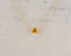 This beautiful and simple necklace is part of our Floating Gem Collection. The rich yellow sapphire is set in a simple three prong setting and is stationary on the cable chain. This necklace can easily be worn everyday or for a night out. Check out our shop for more of this Collection! Metal: 14k Yellow Gold Gemstone Type: Yellow Sapphire Gemstone Shape: Round Gemstone Size: 5.25mm Gemstone Weight: 0.88cts Design Elements: minimalist, solitaire Condition: New Item Weight: 2.5g Item Number: 43846 Yellow Cable Chain Necklace For Gift, Yellow Cable Chain Necklace As Gift, Gift Yellow Cable Chain Necklace, Yellow Gemstone Necklace In 14k Gold, Yellow Gemstone 14k Gold Necklace, Fine Jewelry Yellow 14k Gold Necklace, 14k Gold Yellow Fine Jewelry Necklace, Yellow 14k Gold Fine Jewelry Necklace, Yellow Sapphire Solitaire Jewelry Gift