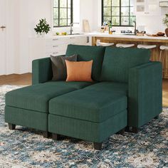 a green couch sitting on top of a rug in a living room