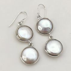 Behold the captivating beauty of these Elegant Freshwater Coin Pearl 925 Solid Sterling Silver Handmade Dangle Drop Earrings. Each earring features a lustrous freshwater coin pearl, its smooth surface catching and reflecting the light in a mesmerizing dance. Suspended from delicate sterling silver chains, these earrings add a touch of timeless elegance and gentle sophistication to any ensemble. More than just pearls, a whisper of timeless allure: Freshwater coin pearls, with their unique flat shape and mesmerizing sheen, symbolize wisdom, grace, and enduring beauty. These earrings become a whisper of confidence, reminding you to embrace your inner radiance and let your gentle shimmer captivate the world around you. Whether you're drawn to classic styles, a touch of vintage glamour, or simp Coin Pearl Earrings, Pearl Jewelry Gift, Handmade Dangle Earrings, Earrings Handmade Dangle, Coin Pearls, Flat Shapes, Silver Chains, Gift For Her Birthday, Vintage Glamour