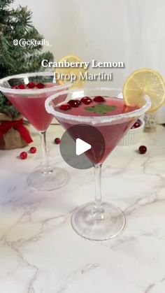 cranberry lemon drop martini in coupe glasses with garnish on the rim