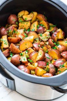 cooked potatoes with parsley in a slow cooker, ready to be served for dinner