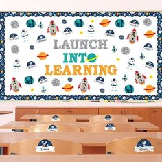 a classroom filled with wooden desks covered in lots of space themed wall hangings