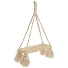 a hanging shelf with two tassels on the bottom and one attached to it