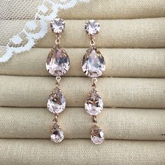 "Heatherly Designs signature teardrops have been kicked up a few glam notches with these extra long dangling shoulder duster earrings made with genuine Swarovski® crystals in blush pink which are set in plated brass. The posts are hypoallergenic surgical steel. ●Nickel free ●Size (Length): 2.75\" or 7cm ●Swarovski crystal color(s): Vintage Rose ●Arrives in our signature Heatherly gift box. Handmade with ❤ by Heather ● ● ● ● ● ● ● ● ● ● ● ● ● ● ● ● ● ● ● ● ● ● ● ● ● ● ● ● →Quantity Discounts list Rose Gold Dangle Crystal Earrings For Wedding, Pink Dangle Crystal Earrings For Wedding, Pink Drop Crystal Earrings For Wedding, Pink Crystal Earrings For Wedding, Pink Crystal Dangle Earrings, Rose Gold Wedding Earrings, Gold Wedding Earrings, Rose Gold Earrings Wedding, Duster Earrings