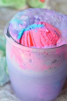 there is a pink and blue ice cream in the cup