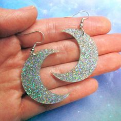 "Turn heads and add a piece of \"wow\" to your attire when you wear these Iridescent Glitter Big Moon Dangle Earrings! 🌈 Each moon pendant is made from laser cut iridescent glitter acrylic. Reflects every color of light in such an amazing way! 🌙 Super light weight and striking Moon Earrings measure 1.5″ tall and hang on your choice of earring hooks! Pick from: ~ Nickel Free Hooks (Seen in Pictures) ~ Stainless Steel Hooks ~ Metal Free Plastic Hooks ~ Clip Ons ~ Titanium Hooks These awesome and Space Rainbow, Big Moon, Earrings Dangle Simple, Crescent Moon Earrings, Glitter Acrylic, Fun Jewelry, Glitter Acrylics, Earrings Simple, Laser Cut Acrylic