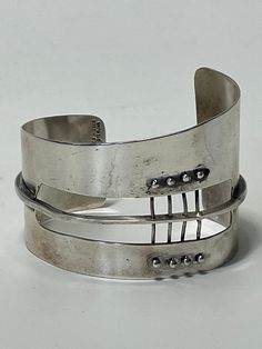 An Extraordinary cuff bracelet designed by Ed Wiener (1918-1991). This rare sculptural modernist piece is one of Wiener's first creations as a jeweler-artist in New York city, circa 1950's. This bracelet is composed by six elements with sinuous curved and free forms shapes which in turn recreates a sculpture with constructivism patterns. It was individually constructed and crafted in solid .925/.999 of polished and patinated sterling silver.  Bio: Ed Wiener (1918-1991), began his career in the artist's circles of the post-Bauhaus. Was very active at Provincetown and the Greenwich village in New York. Work immediately in the early days of the abstract expressionist movement of the post-war period, late 1940's. His most famous customers was the sculptor Louise Nevelson and Martha Graham, the Louise Nevelson, Modernist Jewelry, Art Jewelry Contemporary, Fashion Sites, Art Jewelry, Bracelet Designs, Cuff Bracelet, Jewelry Art, Favorite Jewelry