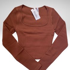 Amazing Seamless Top With Long Sleeves Super Soft And Stretchable Giving You A Figure Hugging Look Available S/M And M/L Fitted Brown Tops With Seamless Collar, Seamless Design Crop Top, Fitted Brown Basic Crop Top, Solid Seamless Tops For Fall, Casual Brown Top With Seamless Construction, Seamless Scoop Neck Top For Fall, Trendy Seamless Brown Crop Top, Trendy Brown Seamless Crop Top, Fall Seamless Scoop Neck Top