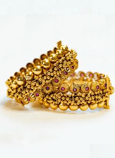 Pothi - Gold Kada Bracelet for Women w/ Cluster Gold balls & Ruby Stone Setting Stone Setting: Ruby Finish: Gold Plated Composition: Metal Alloy Cluster gold beaded bangle for desi women. This is a Kada style bangle set that is the perfect accessory for any Indian outfit. Stunning ruby gemstones adorn this pair of bangles. Elaborated with traditional temple jewelry style beads of gold on these bangles. These women's Kada bracelet set has been handcrafted by artisans & designed by team B Anu with Gold Bangle With Round Beads For Wedding, Gold Beaded Bangle Bracelets For Wedding, Gold Beaded Bracelets For Weddings And Festivals, Festive Bracelets For Celebration, Openable, Festive Wedding Bracelets With Round Beads, Traditional Gold Beaded Bracelets For Rituals, Gold Beaded Bracelets For Diwali, Festive Puja Bracelets With Round Beads, Gold Beads Bracelets For Festivals