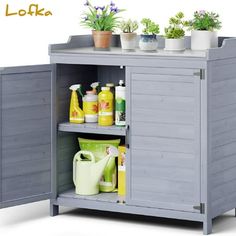 an outdoor storage cabinet with plants and cleaning products on it's shelf, in front of a white background