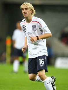 a soccer player is running on the field